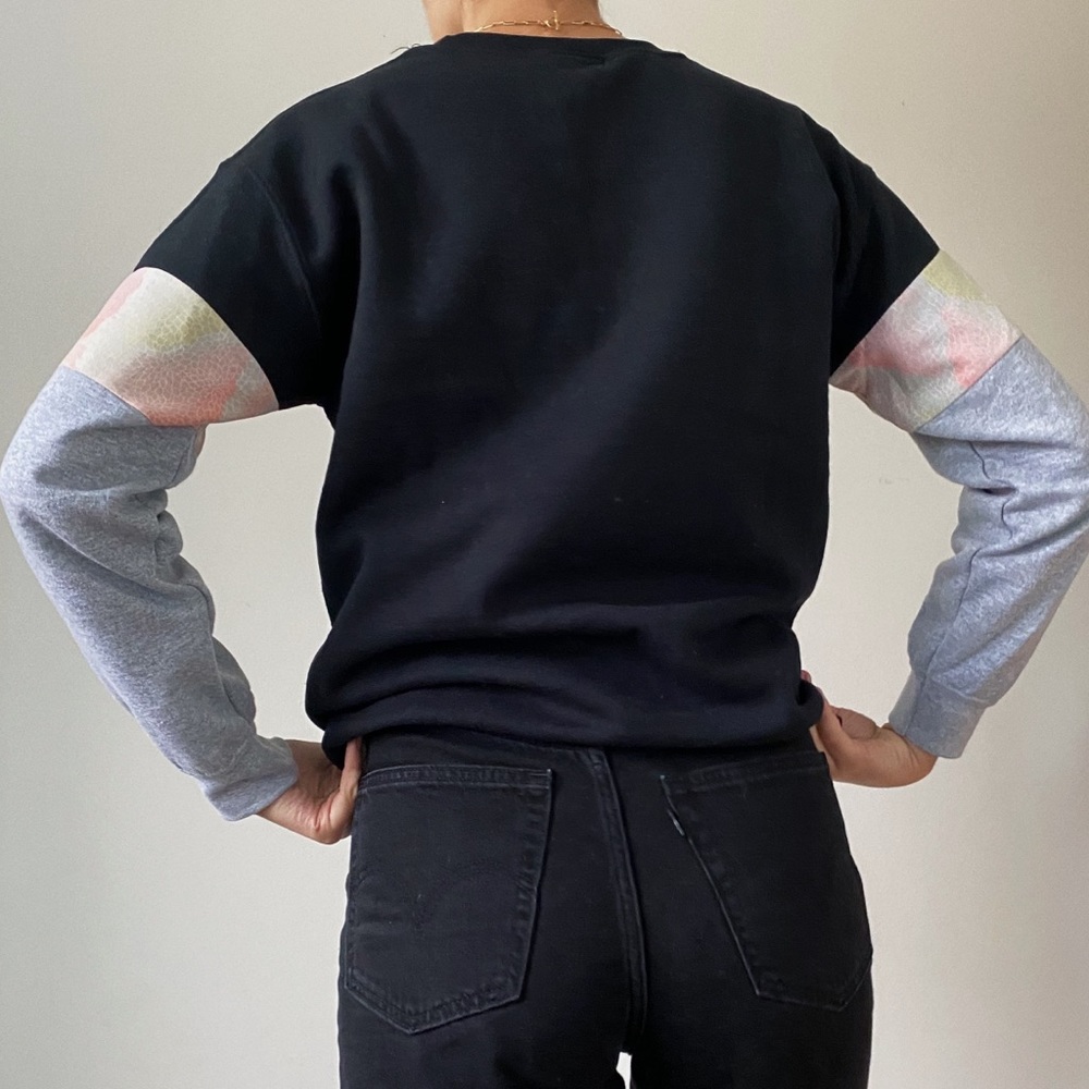 Black crewneck sweater with pink & grey sleeves
